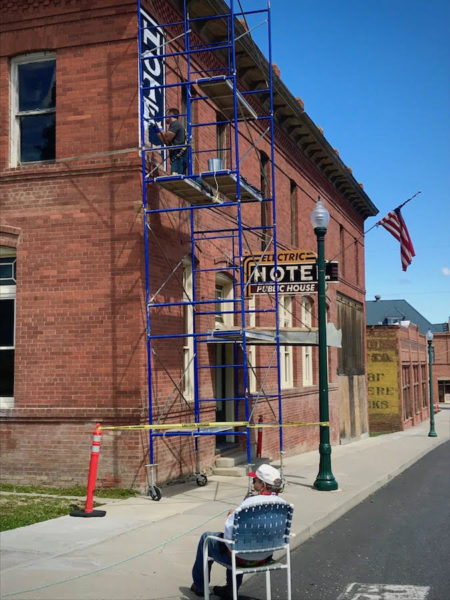 Leslie LePere watches ghost sign restoration